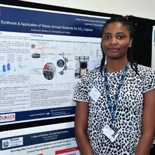 Kofo Awodun standing with research poster