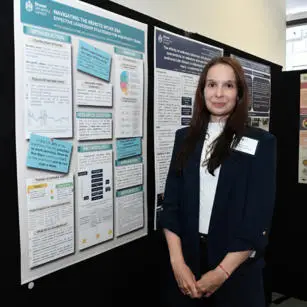 Petra Buresova standing with research poster
